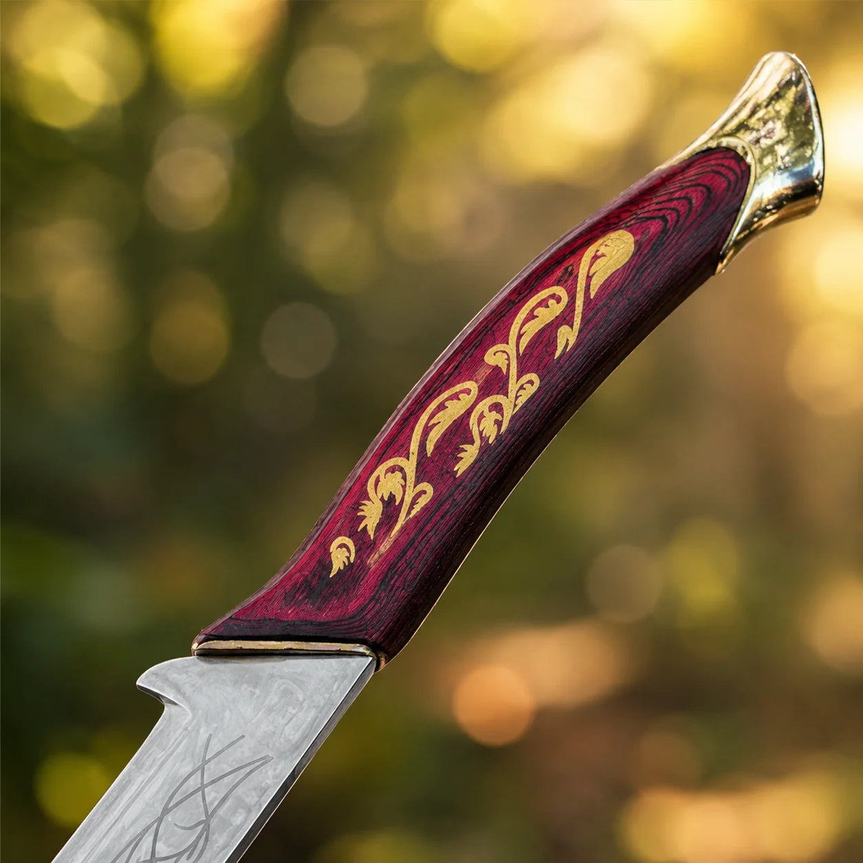 Hadhafang Arwen LOTR display replica collectible featuring a reddish-brown handle with gold elven vines, engraved metallic blade, and black stitched scabbard