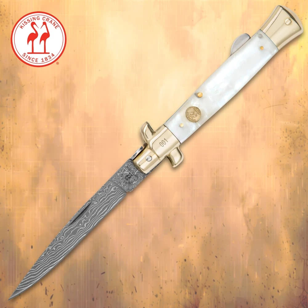 Luxury Damascus pearl stiletto folder closed with genuine white pearl handle and brass bolsters