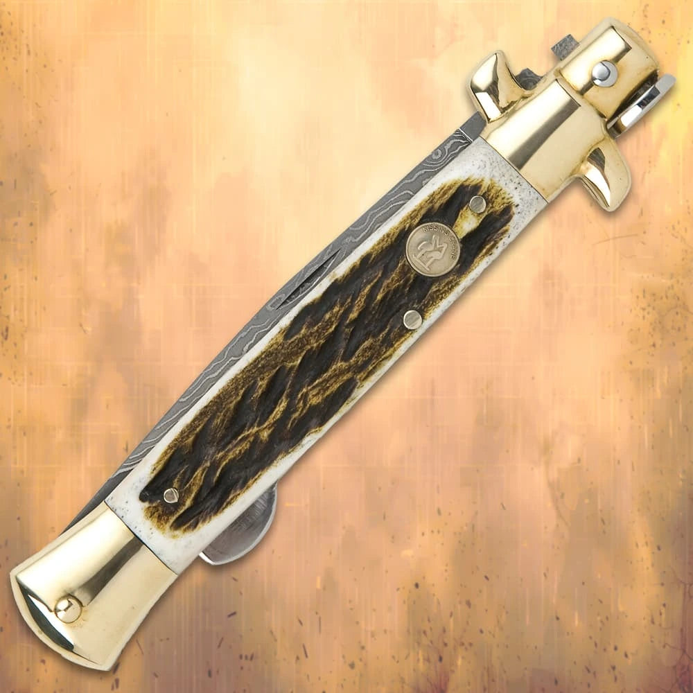 Luxury Damascus pearl stiletto folder closed with genuine white pearl handle and brass bolsters