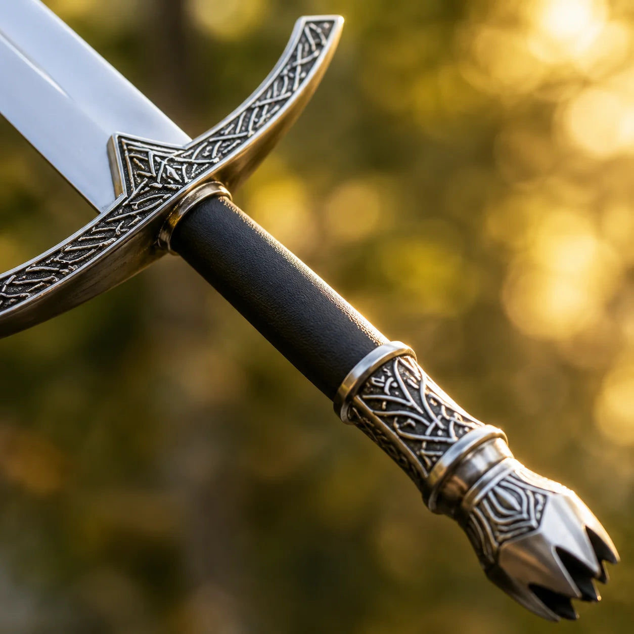Witch-King Dominion Sword LOTR collectible display replica featuring detailed antique silver engraved guard and matte black handle resting on natural stone backdrop