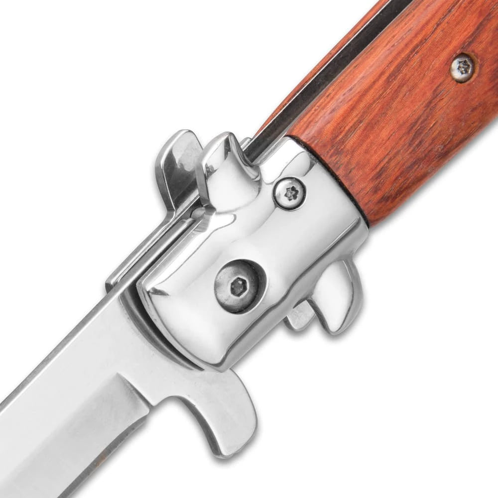 German assisted stiletto pocket knife closed with wooden handle and stainless bolsters